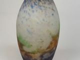 a blue and white vase sitting on a white surface