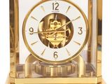 a gold clock that is sitting on top of a table
