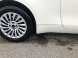 a white car that is parked on the side of the road