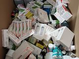 a cardboard box full of medicine and other medical supplies