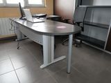 a desk with a laptop computer and a chair in a room