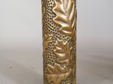 a gold vase with a design on it on a table