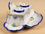 a blue and white dish with a lid on a wooden table