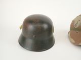 two helmets are sitting next to each other on a white surface