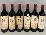 six bottles of wine are lined up in a row