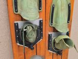 a pair of shoes and a pair of skis hanging on a wall