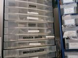 a stack of plastic drawers on a table with plastic containers on it