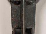 a close up of a metal object with a face on it