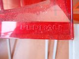 a close up of a red plastic object on a table