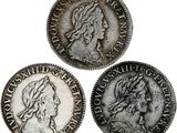 trois pièces d'argent sur lesquelles figurent respectivement la tête d'une femme et celle d'un homme