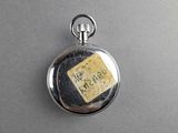 an image of a pocket watch with a label on it