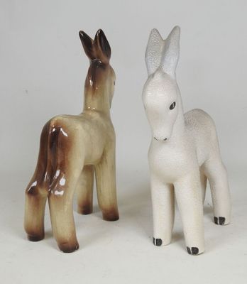 two figurines of donkeys standing next to each other