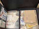 a suitcase with a lot of stamps and papers inside of it