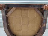 a chair with a seat made out of wood and fabric