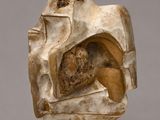 an image of a sculpture of a man sitting on top of a rock