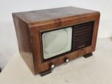 an old fashioned television sitting on top of a table