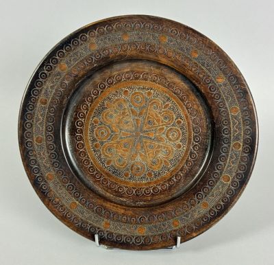 an image of a decorative plate on a stand on a white background