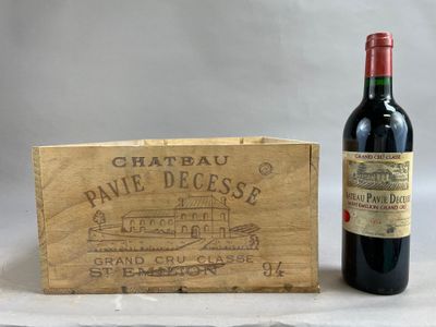 a bottle of wine sitting next to a wooden box
