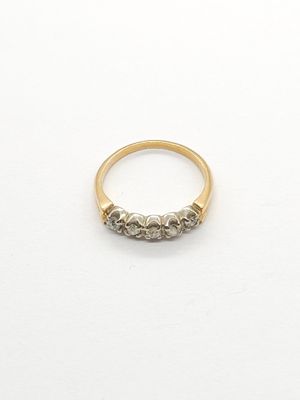a close up of a gold ring with three diamonds on it