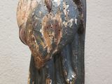 an old statue of a man with a beard and a hat