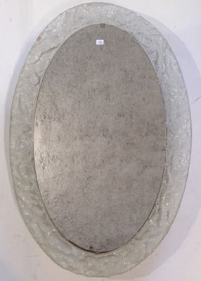a round mirror on the wall in the bathroom