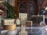 a glass table with a lot of antique items on it