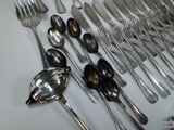 a lot of silver spoons and spoons on the table