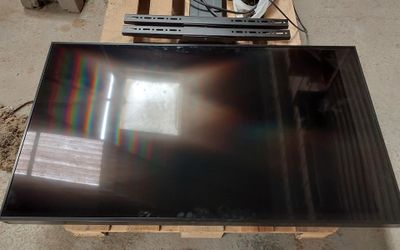 a flat screen tv sitting on a pallet on the floor