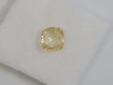 a yellow diamond sits on top of a white cloth