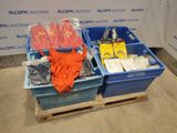 two blue bins filled with assorted items sitting on a pallet