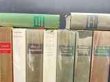 several books are lined up in a row on a table