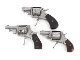 three revolvers with wooden grips on a white background