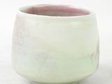 a close up of a cup on a white surface