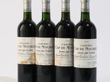 four bottles of wine are lined up on a white surface