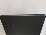 the back of a black laptop computer sitting on top of a table