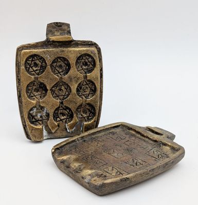 an image of a small bottle and a small tray on a white surface