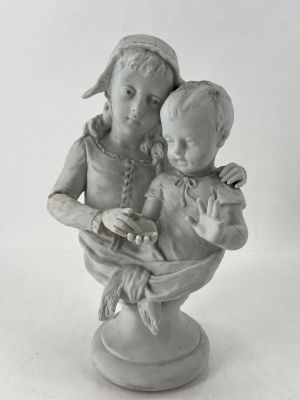 a statue of a woman holding a child in a bowl
