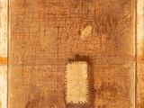 an old picture of a piece of wood with a square hole in it
