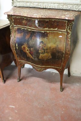 a small table with a painting on it next to a mirror