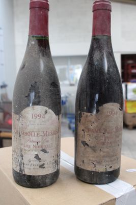 two bottles of wine sitting on top of a cardboard box