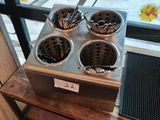 a picture of a counter with three pots of food on it