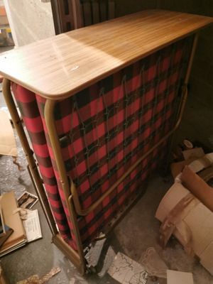 a wooden table with a red and black checkered cloth on it