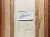 an old picture of a wooden frame with a piece of paper in it