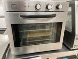 a silver oven sitting on top of a counter in a kitchen