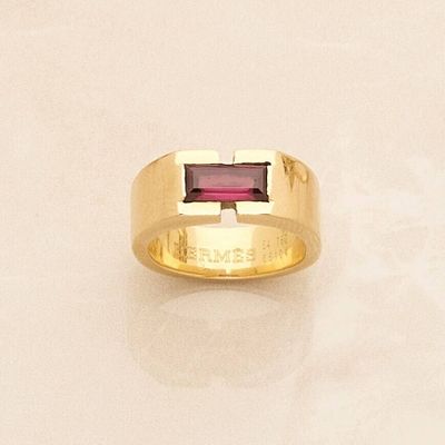 yellow gold ring with a garnett stone in the center