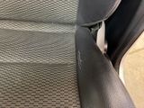 a close up of a car seat with the arm rest down