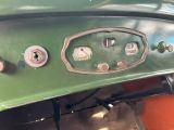 a close up of the dashboard of a green car