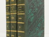 two green books sitting on top of each other on a white surface