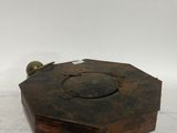a small wooden box with a metal handle on a white surface