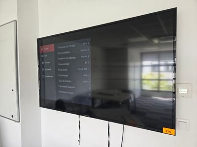 a flat screen tv mounted on a wall in a room